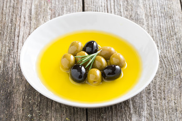 fresh olive oil and olives in a plate