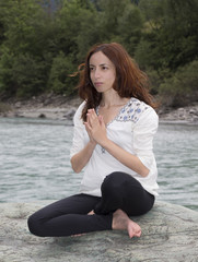 Fototapeta na wymiar Woman meditating outdoors