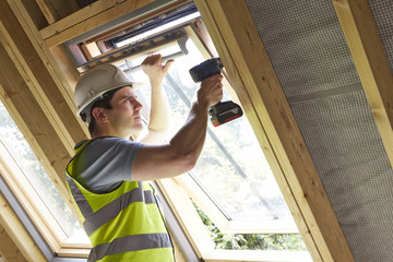 Construction Worker Using Drill To Install Window - obrazy, fototapety, plakaty