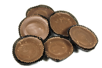 Arrangement of Six Brown Chocolates in Protective Papers