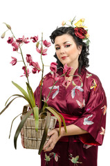 Kimono woman holding wicker pot of orchid