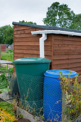 Water storage barrel with garden shed