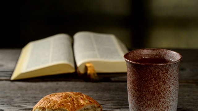 bible with chalice and bread, panning,sliding, tilt