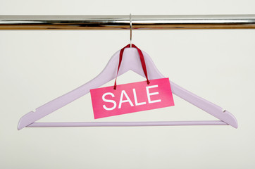 Empty hanger on a rack of clothes with the sale sign. - 66355207