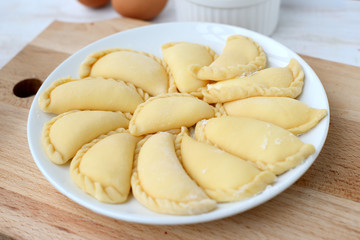 Making of varenyki or pierogy with cottage cheese (curd).