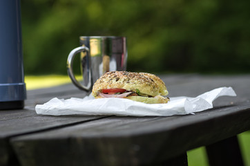 Breakfast in the park, thermos, sandwich and cup