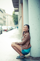 Fototapeta premium beautiful african young woman listening music earphones