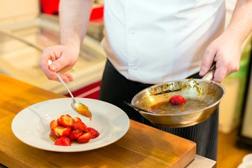 Human hands cooking fruits in kitchen