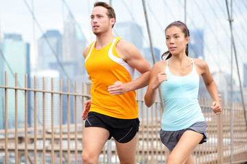 Running couple jogging in New York City