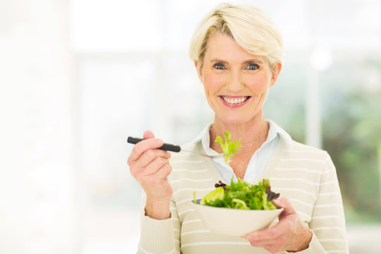senior female vegetarian eating salad