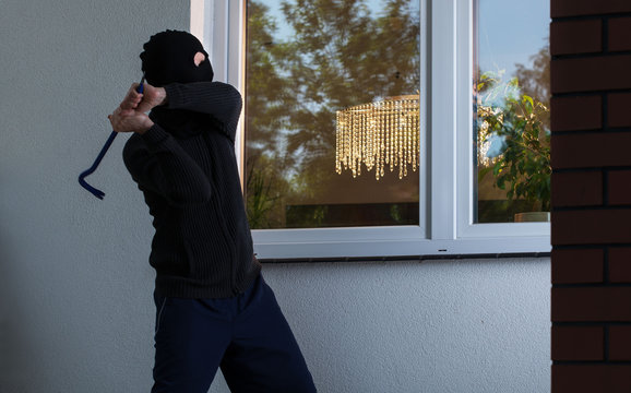 Burglar tries to smash a window