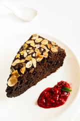 Chocolate cake decorated with almonds and raspberry jam