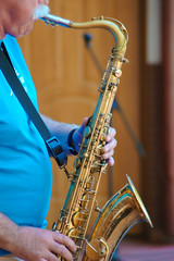 Adult man playing the saxophone