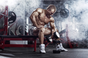 Fototapeta na wymiar bodybuilder athletic guy execute exercise biceps with dumbbells