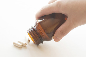 Pouring capsules from a pill bottle