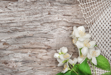 White flowers on lace fabric and old wood