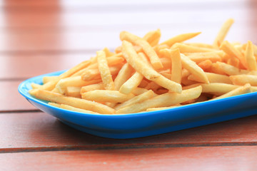 bowl of french fries on wooden table