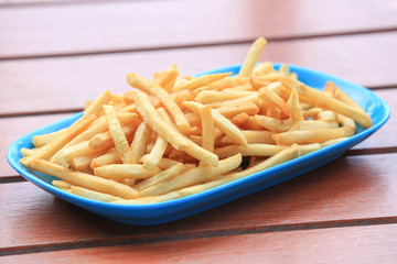 bowl of french fries on wooden table