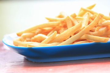 bowl of french fries on wooden table