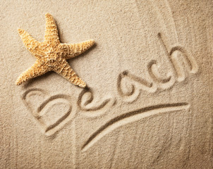 Fototapeta na wymiar Summer inscription on sand with seastar
