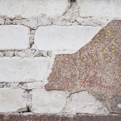 Brick wall with the whitewash falling off © exopixel