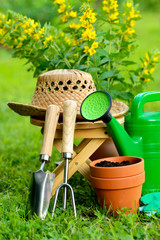 Gardening tools on green background and grass