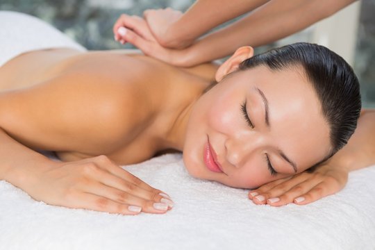 Content brunette enjoying a back massage