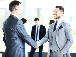 Fototapeta premium Business people shaking hands, finishing up a meeting 