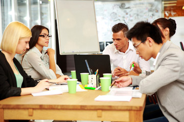 Business people having meeting around table in office
