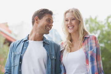 Hip young couple laughing together