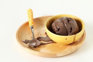 chocolate ice cream in wooden plate on white background