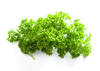 bunch of parsley on a white background. healthy spring greens