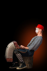 Clown playing on accordion