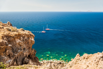 Two yachts on the coast of the beautiful blue Aegean sea