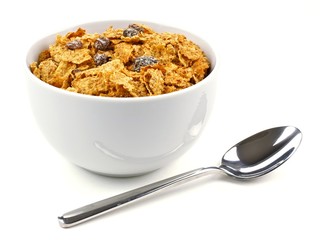 Bowl of bran flakes and raisin cereal with spoon