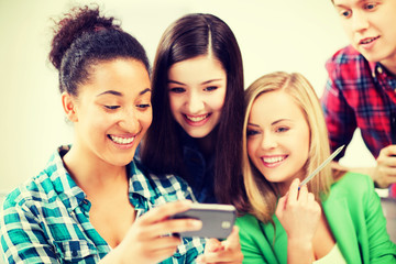 students looking at smartphone at school