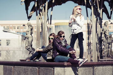 Group of teenage school girls against a city fountain
