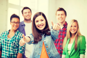 students showing thumbs up at school