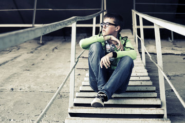 Young man in depression sitting on the steps