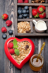 Granola muesli with berries, honey, nuts and milk.