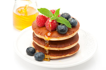Pancake. Pancakes with raspberries, blueberries and honey
