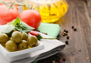 oil, tomatoes and olives on a napkin