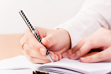 Woman writing in organizer