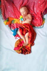 Magical baby lying in red, blue background