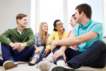 five smiling teenagers having fun at home