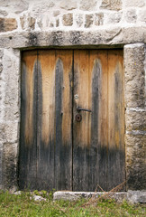 Old wooden door in a stone house