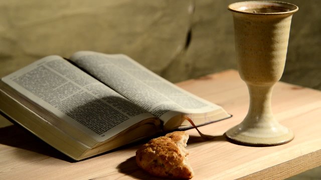 bible with chalice and bread, panning,sliding