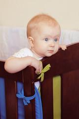 Cute baby girl in her crib