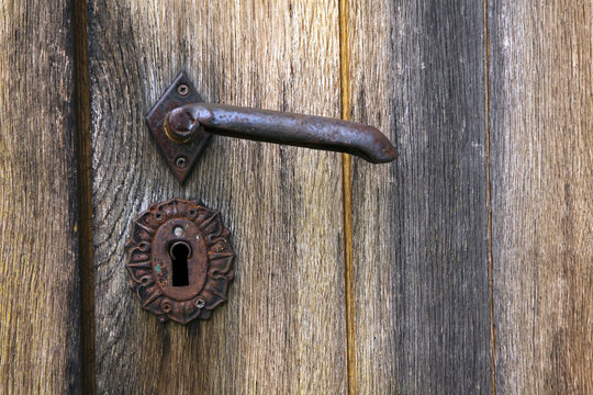 Old handle in a wooden door
