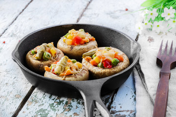 Baked mushrooms with cheese and vegetables